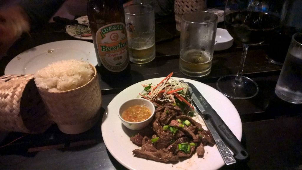 Traditional Lao dish with sticky rice, spicy papaya salad and meat.