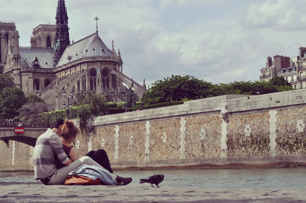 The couple is sitting in the park with each other.