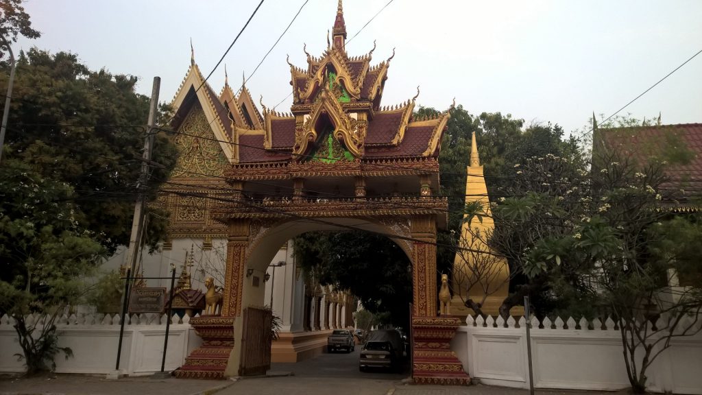 A golden gate in front of the temple in Vientiane.