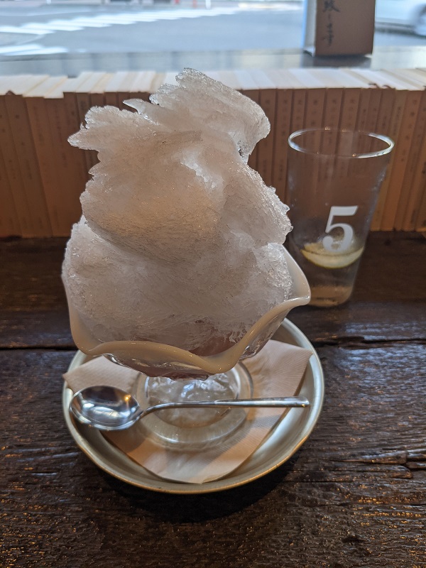 Japanese snow cone in front of books on the window