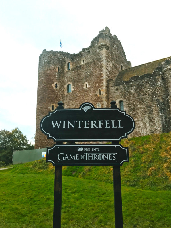 A sign to Doune Castle performing imaginary Winterfell in the tv series Game of Thrones