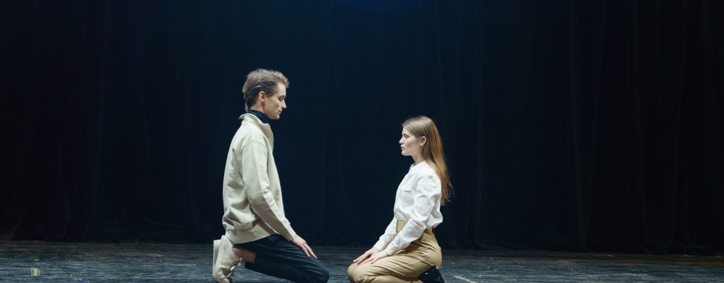 Theatre's digital marketing needs inspiring pictures and videos from theatre. In this picture man and woman sitting on the theatre's stage.