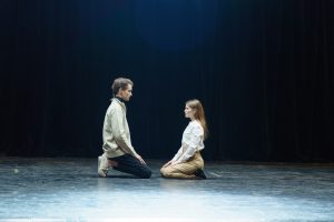 Theatre's digital marketing needs inspiring pictures and videos from theatre. In this picture man and woman sitting on the theatre's stage.