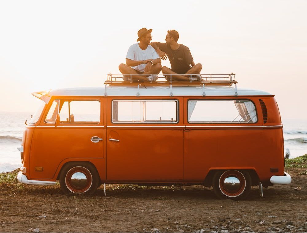 Backpackers on top of the campervan