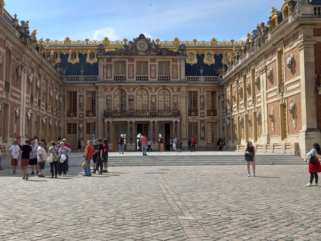 The main castle in Versailles in France.In the picture there are visitors at the entrance.