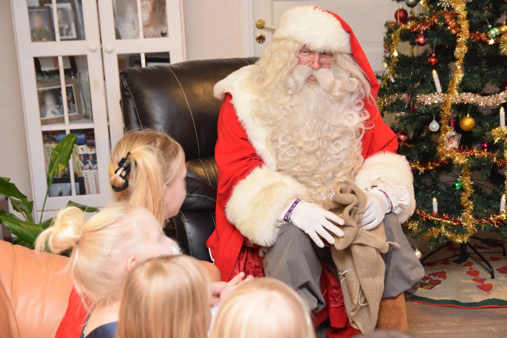 Santa and excited children on Christmas