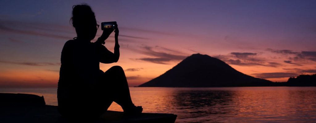 Sunset over Manado Tua island in Bunaken National Park, Indonesia.