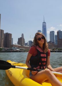 A person kayaking in New York in the summer.