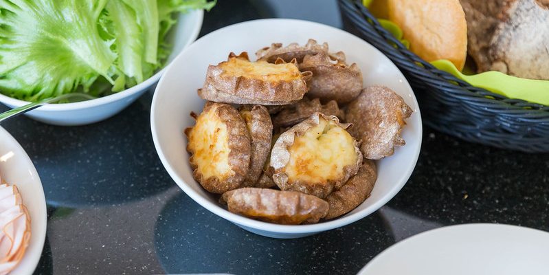 Traditonal Finnish Karelian pies in a bowl on a table.