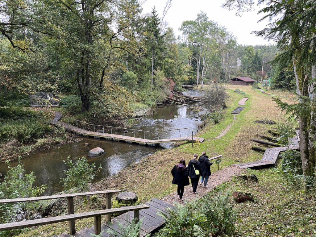 People walking on the Valguma barefoot trail in Latvia.