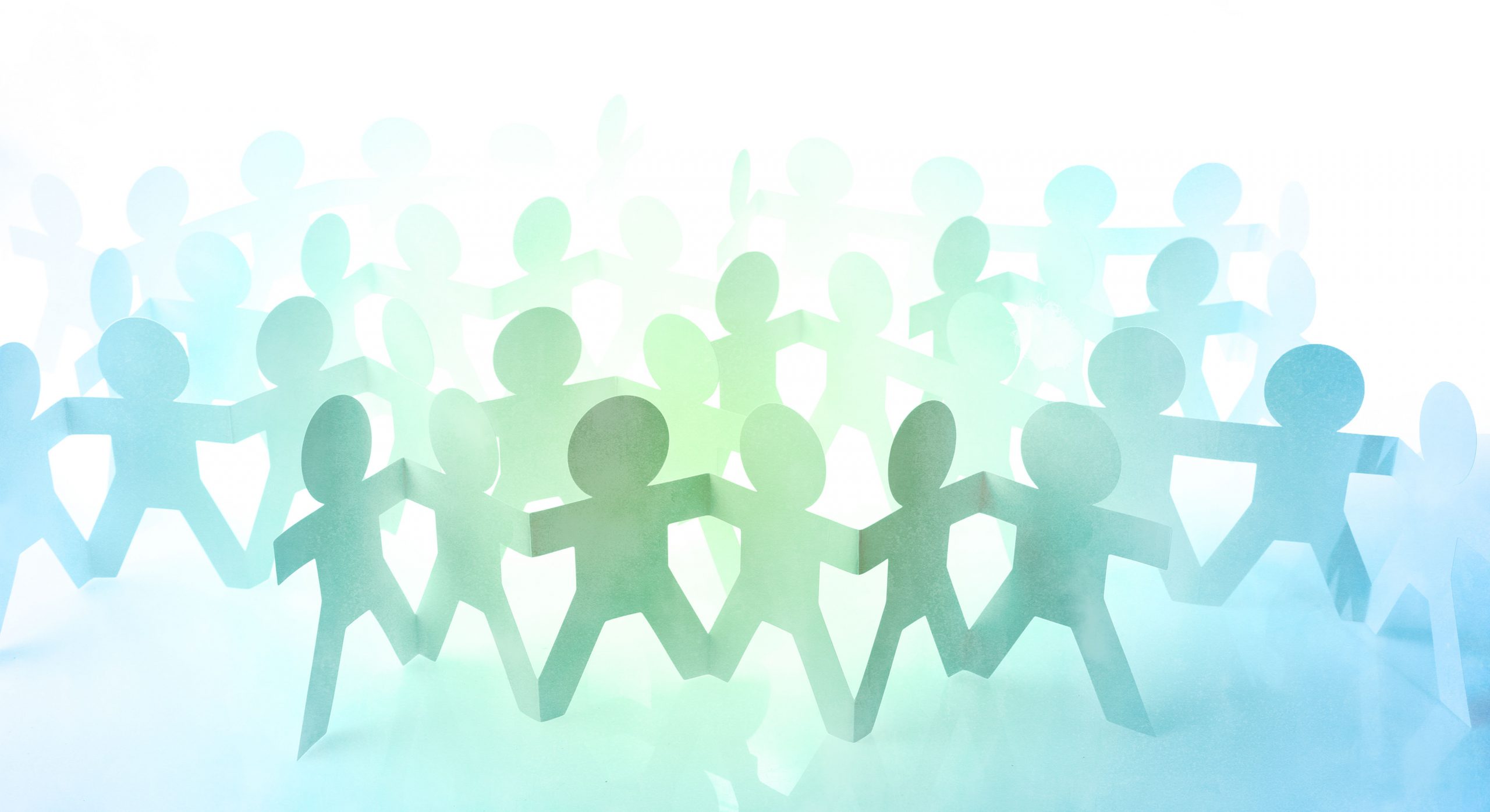 Team of paper chain people united together holding hands