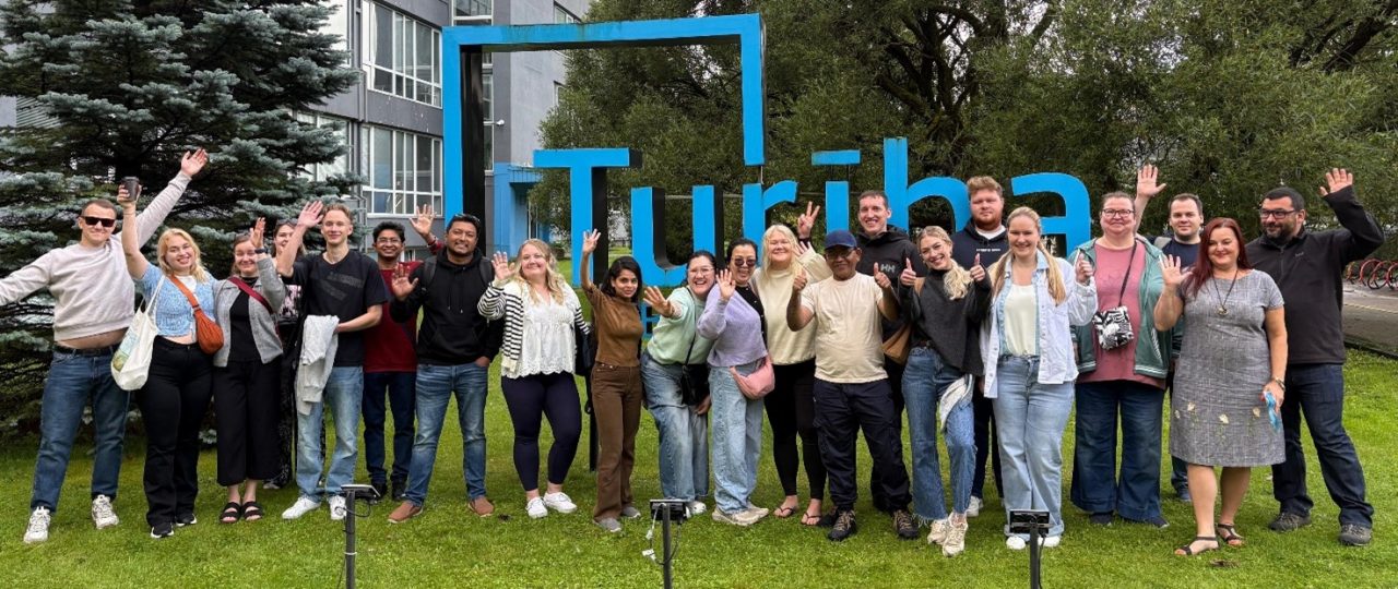 Severa people standing on Turiba university yard.
