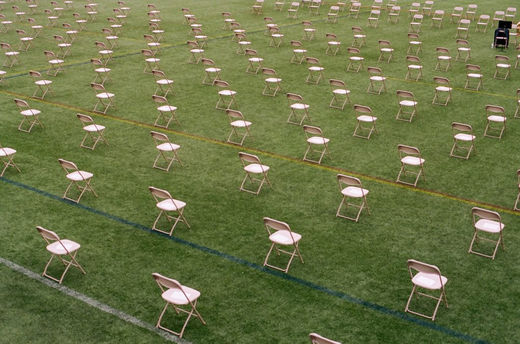 Chairs that are separated between them for an event in a park.