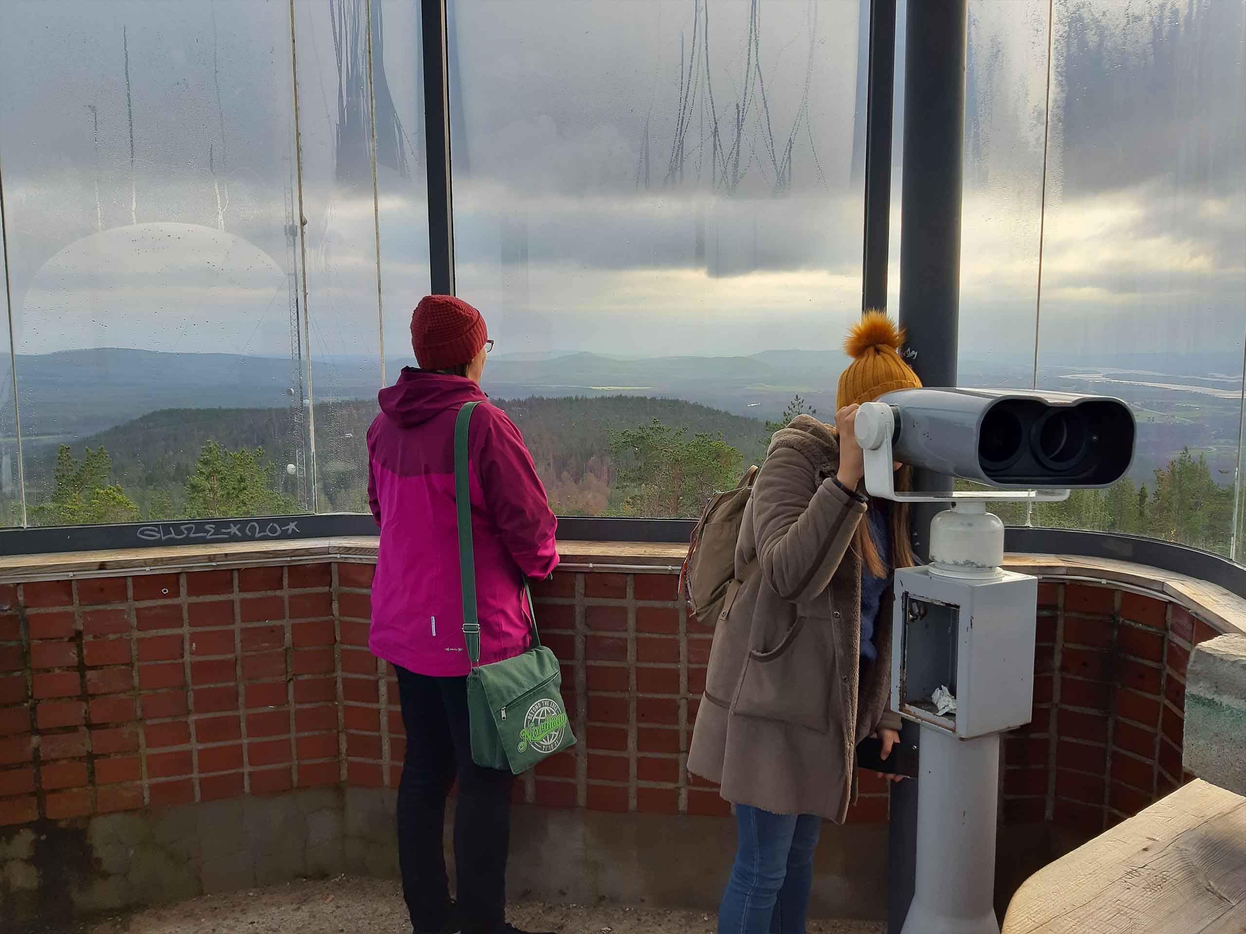 Two persons starnding at the top of the sightseeing tower in Aavasaksa, Ylitornio, Finland